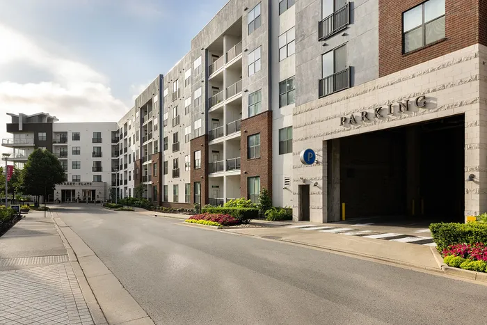 Modern apartment complex exterior featuring sleek architecture, abundant natural light, and convenient parking access.