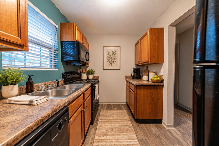 Charming kitchen with modern appliances, wooden cabinetry, and elegant countertops, enhanced by natural light and stylish decor.