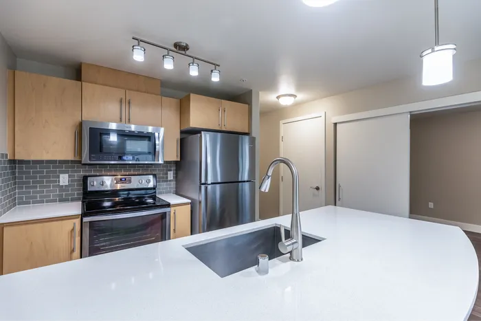 a kitchen with wooden cabinets and stainless steel appliances.