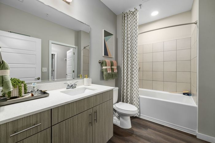 bathroom with large sink area and tub