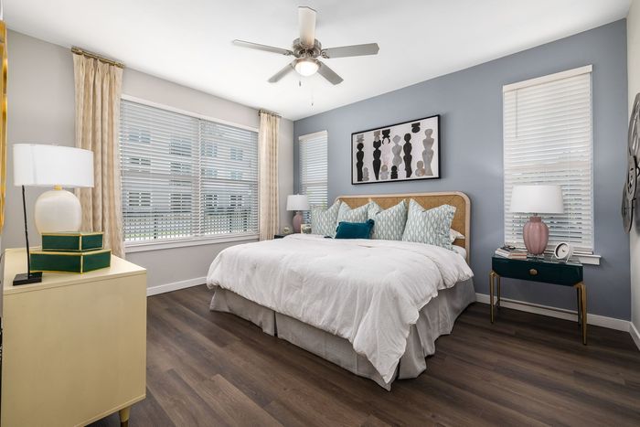 spacious room with bedroom furniture and natural light from windows