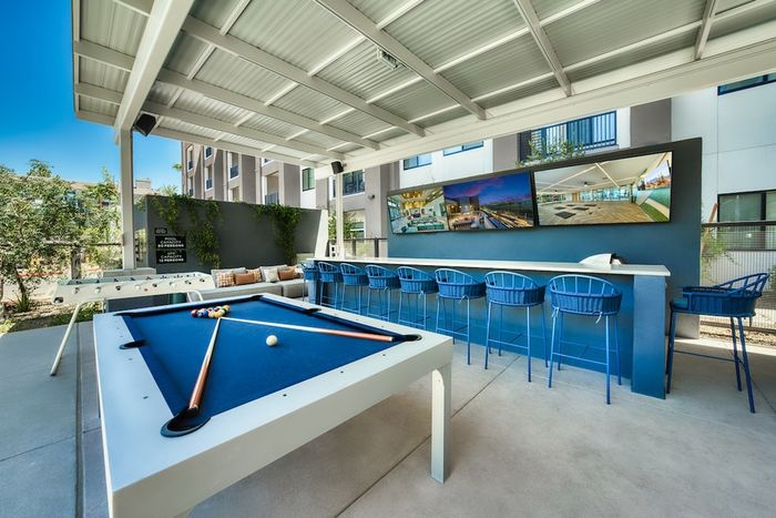 Outdoor bar with pool table and TVs