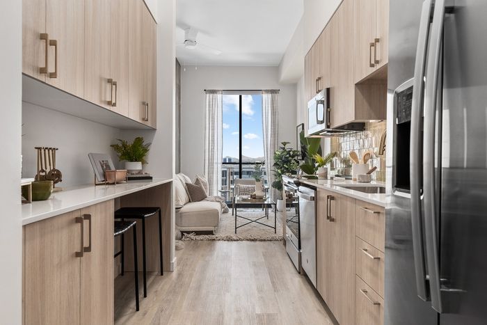 Studio Model Unit - Kitchen with stainless steel appliance and  quartz countertops at Moontower Phoenix