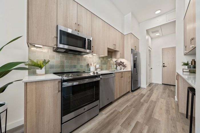 kitchen with green tile backsplash