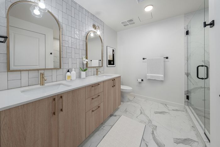 model bathroom with quartz countertops and walk in shower
