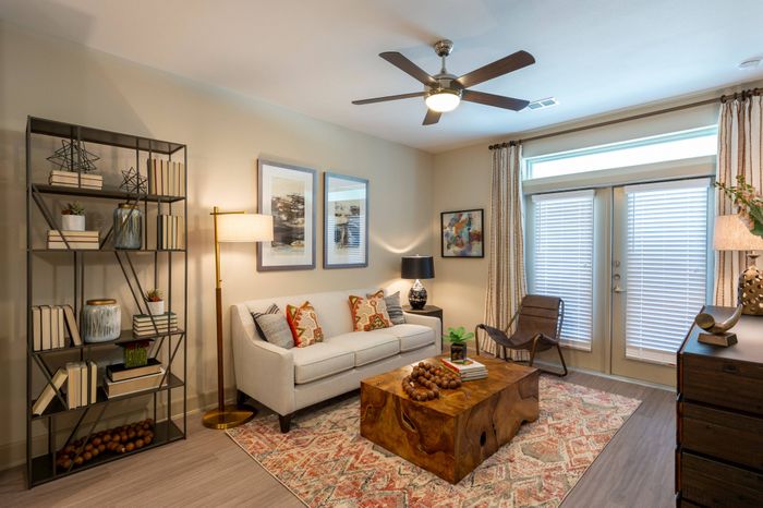 Living area with sofa, coffee table and book shelving