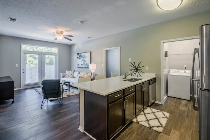 furnished living room and kitchen with wood look flooring