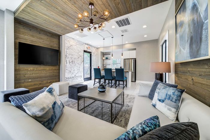 furnished clubroom with tvs