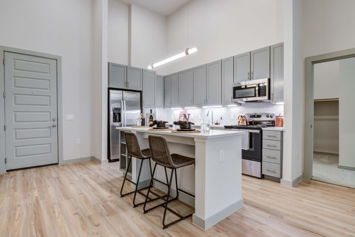 chef-inspired kitchen with stainless steel appliances, plentiful storage and large kitchen island