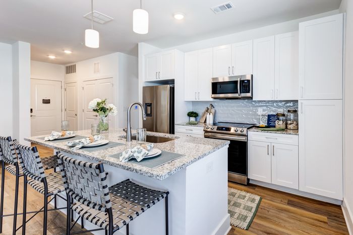 Kitchen with stainless steel appliances and island with seating