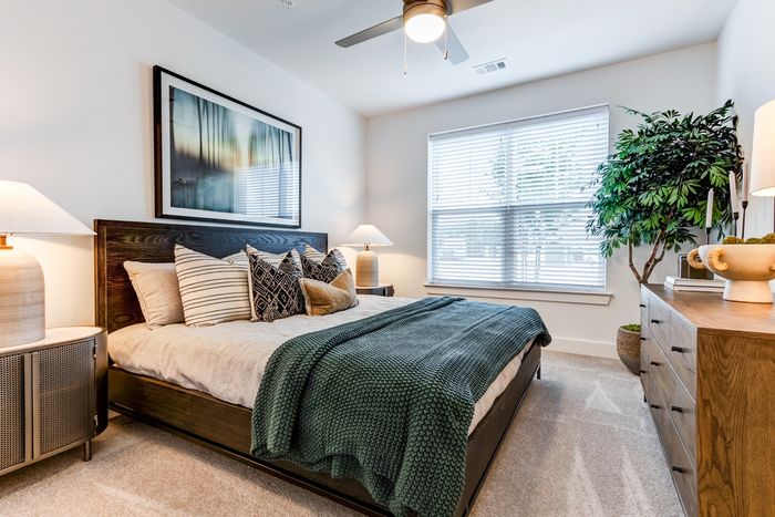 Room with bed, end tables, and dresser