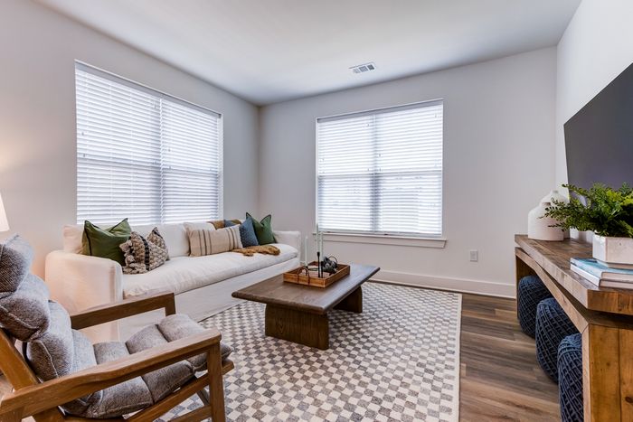 Living room with couch, chair, table, and tv stand