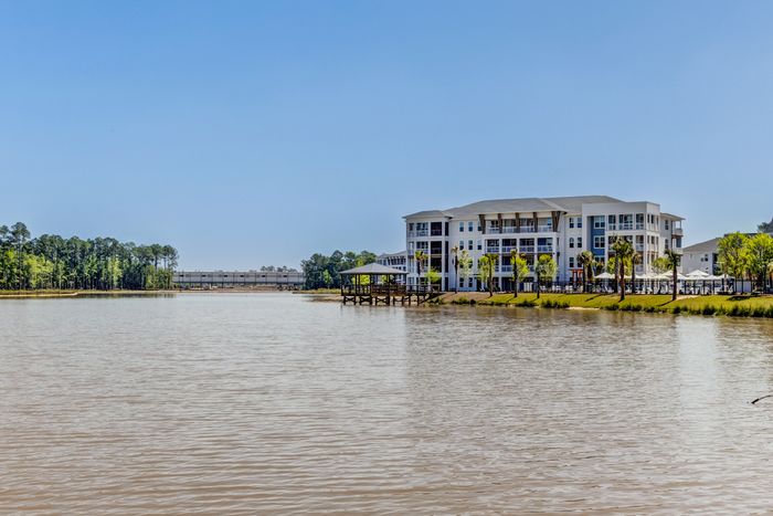 Exterior of property with surrounding lake