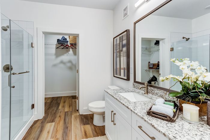 Bathroom with granite countertops and shower opening to the closest