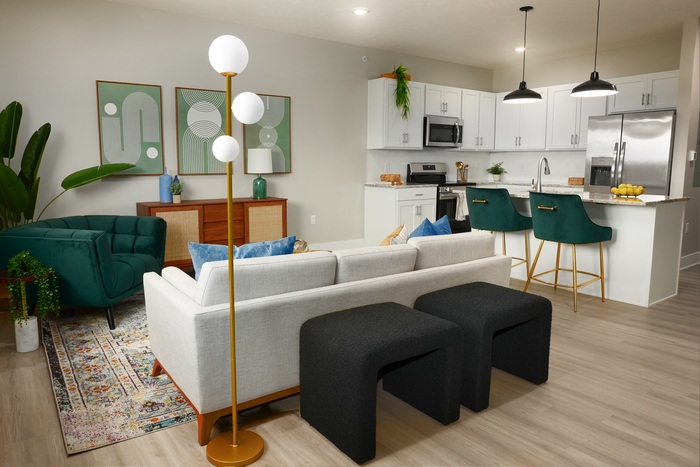 Spacious living room with hardwood flooring along side the kitchen