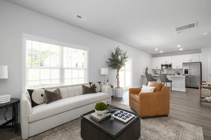 Living Room with bay windows and open floorplan kitchen