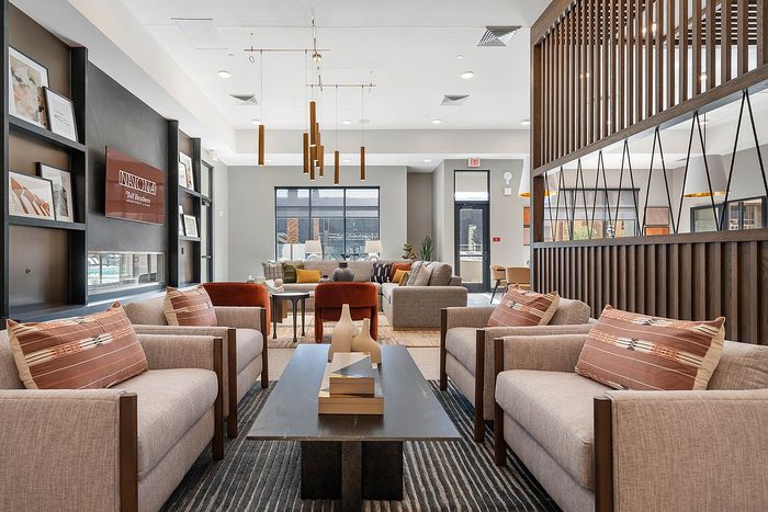 Interior clubhouse with lounge seating, ceiling lights, flat screen tv