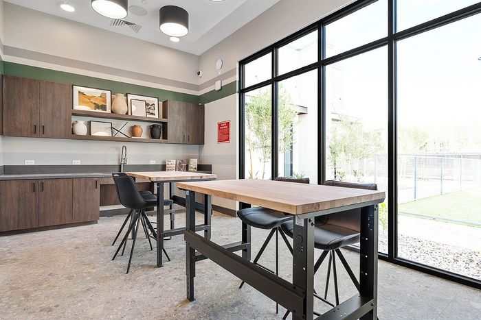 Interior co-working lounge with large windows, ceiling lights