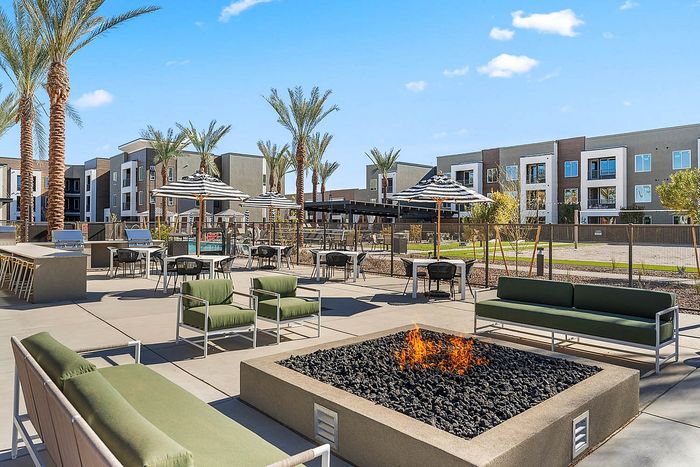 Navona exterior firepit and bbq grills, outdoor lounge seating, outdoor umbrellas