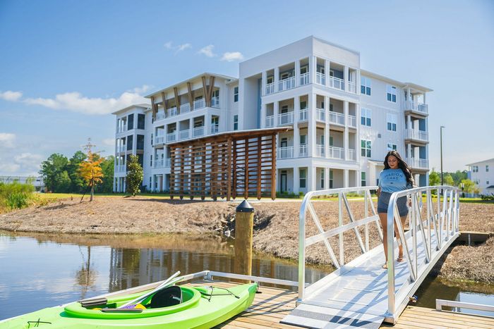 woman walking on dock to kayak
