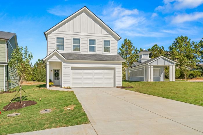 Exrerior of home with 2 car garage in the day time