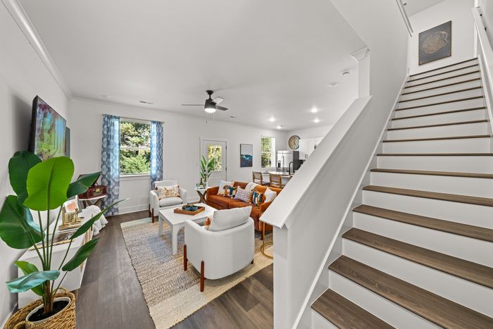 View of the hardwood style stairs and furnished living room