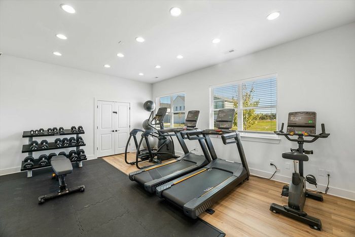 Furnished gym with cardio and lifting equipment