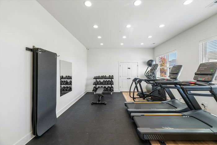Furnished gym with cardio and lifting equipment