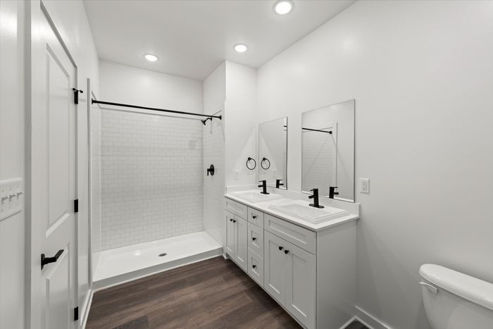 Bathroom with standing shower and two sinks