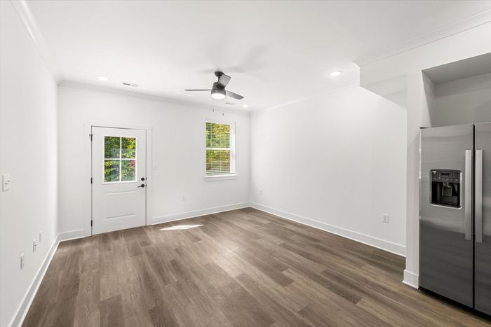 Unfurnished dining room with hardwood style flooring and lighted ceiling fan