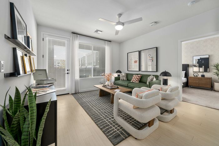 Navona living room space, furnished, hard wood floors, ceiling lighting, large window