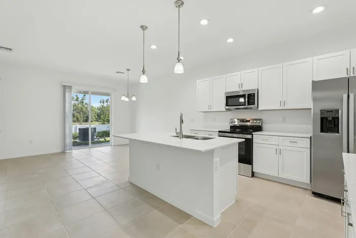 Open Concept Kitchen with eat in island and stainless steel appliances
