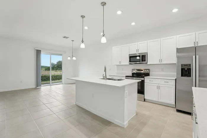 Open Concept Kitchen with eat in island and stainless steel appliances