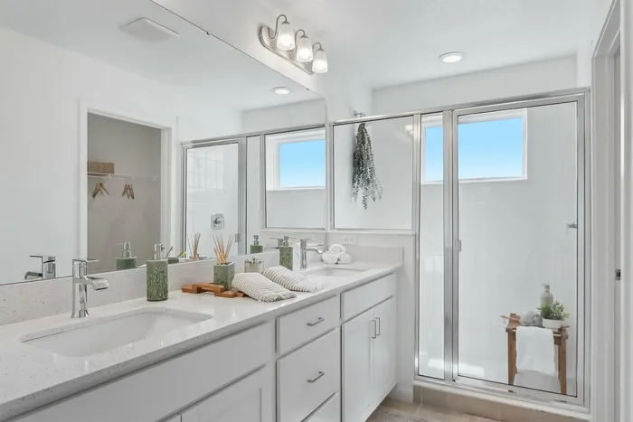 Large bathroom with glass walk-in shower and double vanity