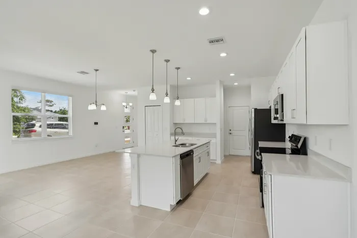 Open Concept Kitchen with eat in island and stainless steel appliances