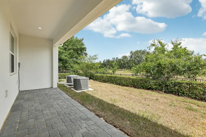 Backyard view of townhomes with covered patio
