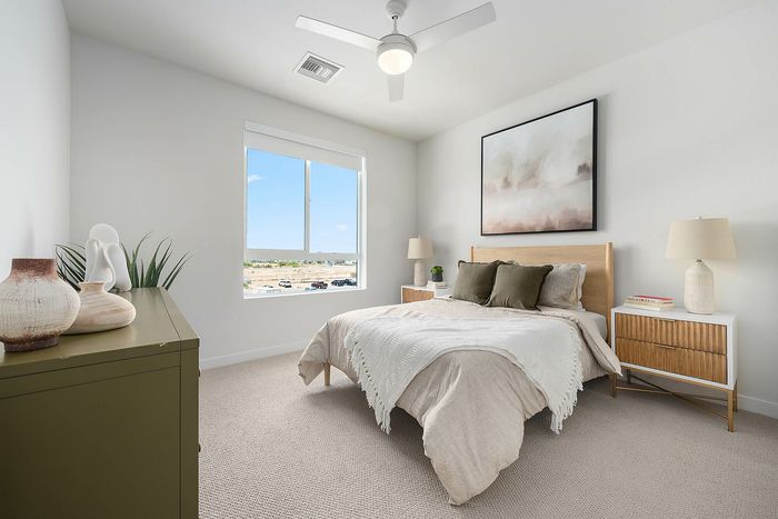 Navona bedroom furnished, carpet floor, ceiling fan, large window