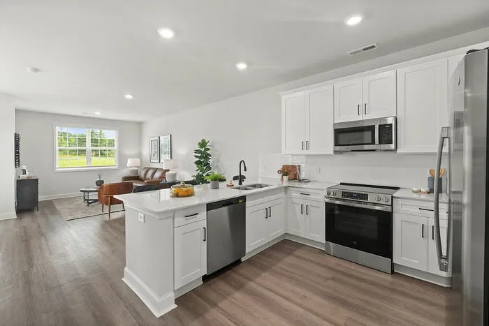 Open concept kitchen with a breakfast bar at Spire at Darrowby Ridge townhomes in Burlington, NC.