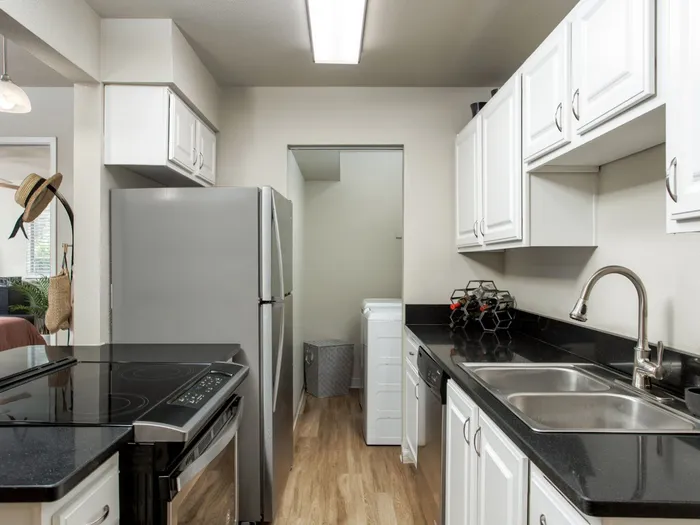 Kitchen with Stainless Steel Appliances, Modern Countertops and adjacent to full-size washer and Dryer