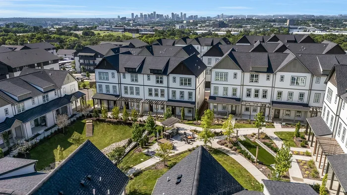 Charming townhouse community with modern architecture and lush green spaces, offering stunning city skyline views.