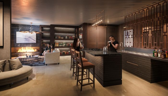 Stylish resident lounge with soft seating, bar-style island, and warm lighting.
