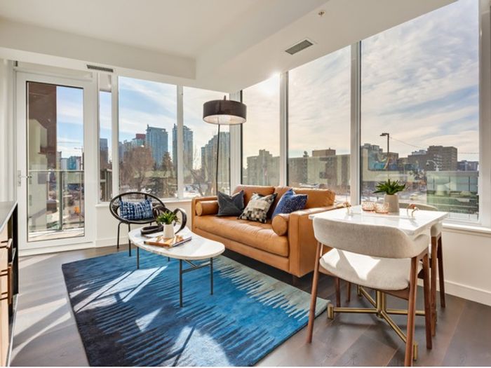 Bright and stylish corner unit featuring floor-to-ceiling windows, hardwood floors, and sweeping city views&mdash;perfect for relaxing or entertaining.