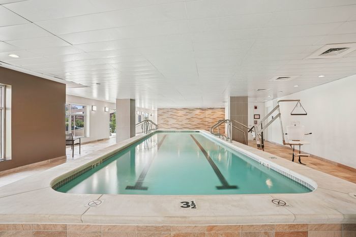 Luxurious indoor swimming pool with elegant lighting and modern design elements, perfect for relaxation and leisure.