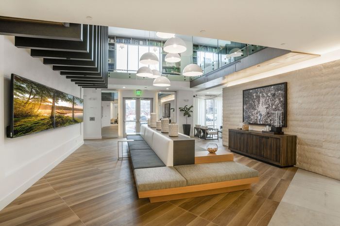 Luxurious modern lobby with elegant lighting, stylish seating, and expansive artwork, perfect for a sophisticated atmosphere.