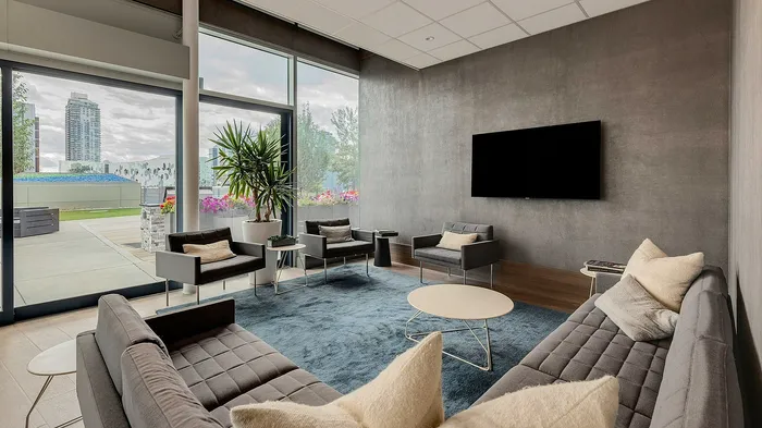 Elegant lounge with modern furnishings, large windows, and cityscape views, offering a perfect blend of style and comfort.