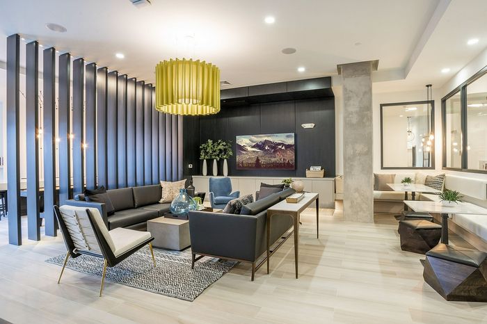 Modern and inviting lounge area featuring sleek furniture, a large decorative light fixture, and an elegant open layout, perfect for entertaining.