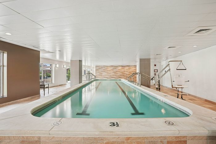 Luxurious indoor swimming pool with elegant lighting and modern design, perfect for relaxation and fitness.