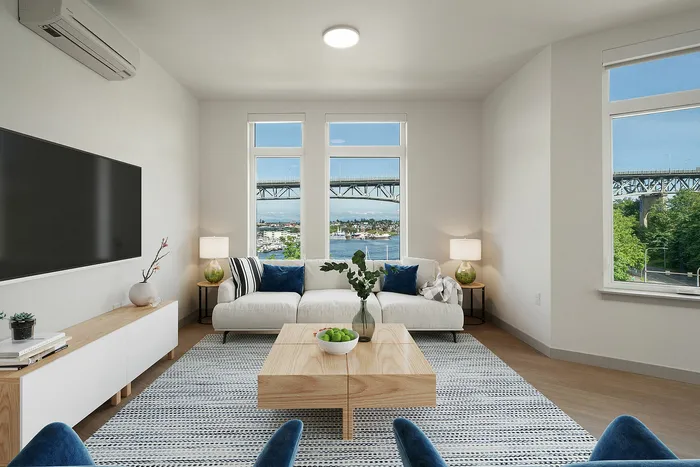 Chic living room with modern d&eacute;cor, offering stunning river and bridge views through expansive windows.