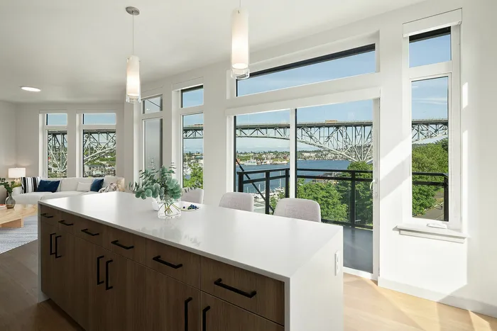 Chic modern apartment with panoramic window views of the bridge and river, featuring a stylish open-plan kitchen and living area.