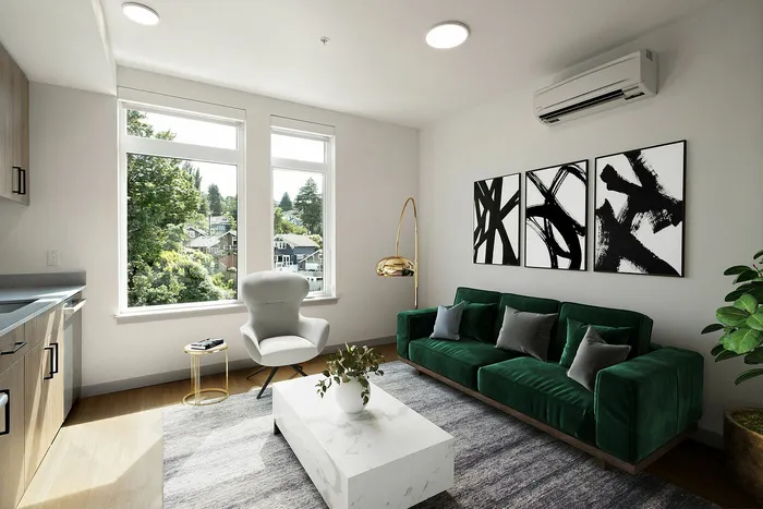 Modern living room with sleek green velvet sofa, abstract wall art, and large windows offering scenic views.